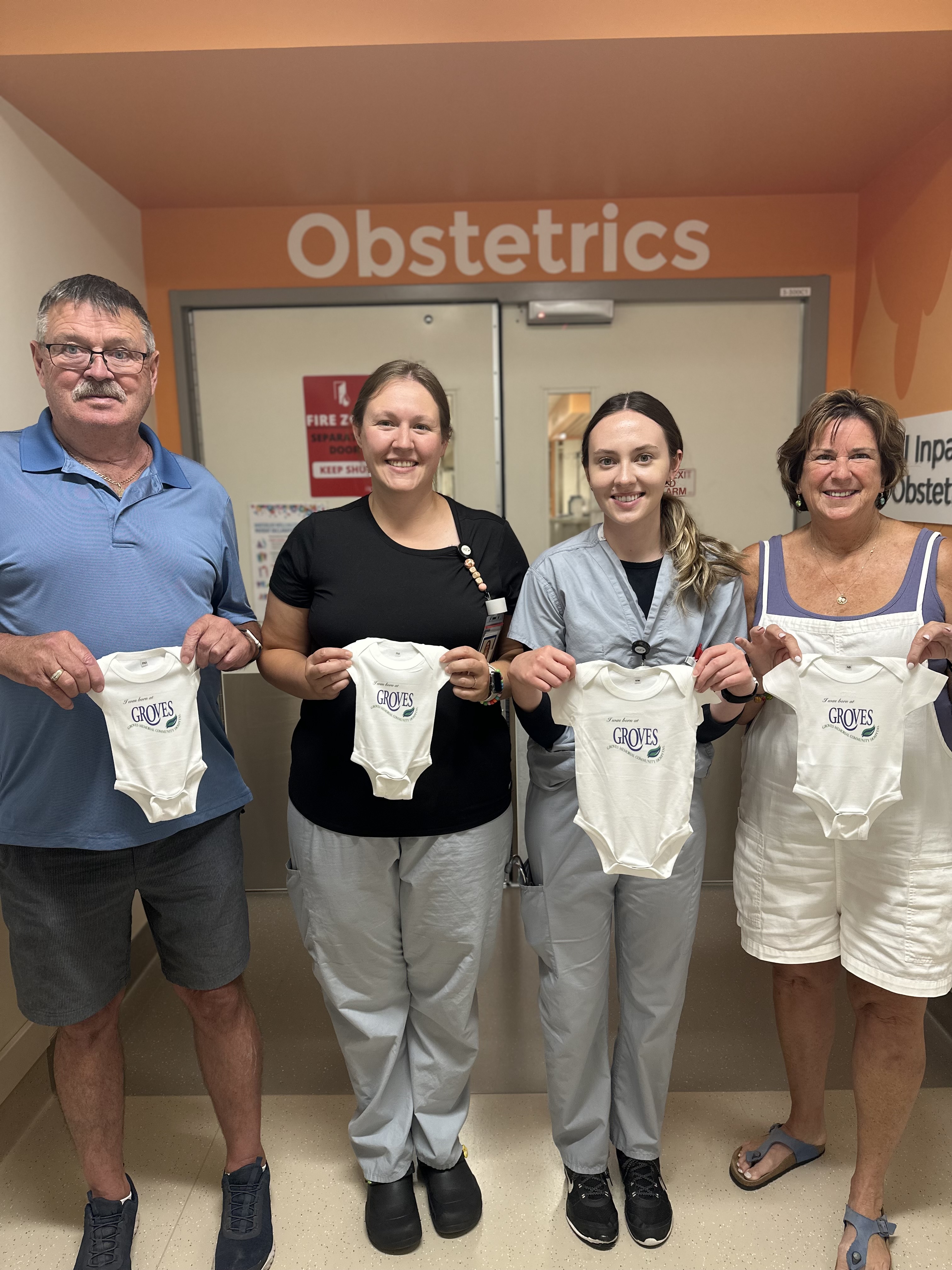 Bill & Cheryl Rowe Present the first Groves Baby Onesies to GMCH OB Nurses, Justine & Paige